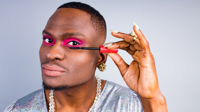 Man applying mascara to eyes