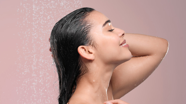 Woman rinsing her hair in shower
