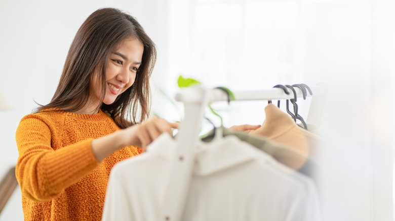 woman looking at a clothing rack 