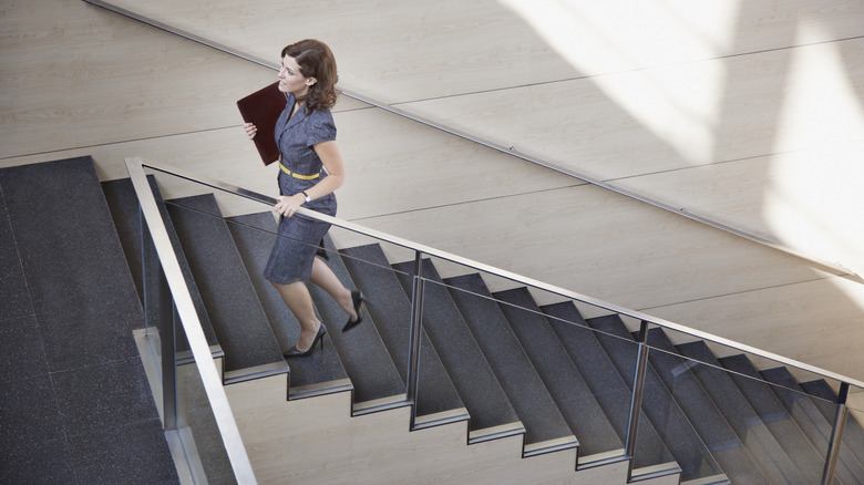 woman walking up office stairs