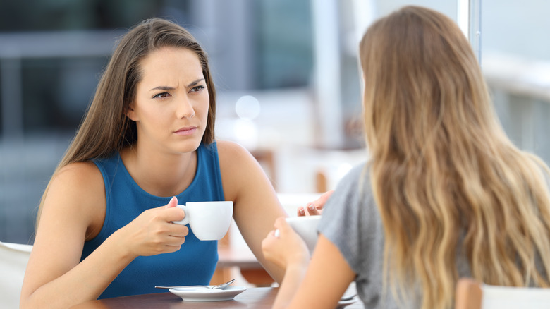 Two woman having a conversation over coffee
