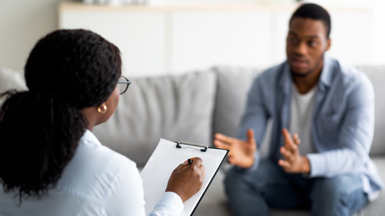 young man speaking to therapist