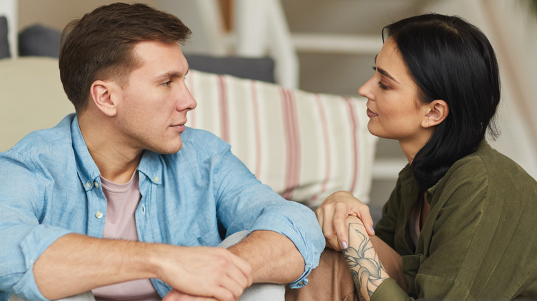 man and woman having serious conversation