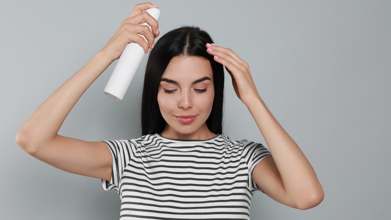 woman spraying roots