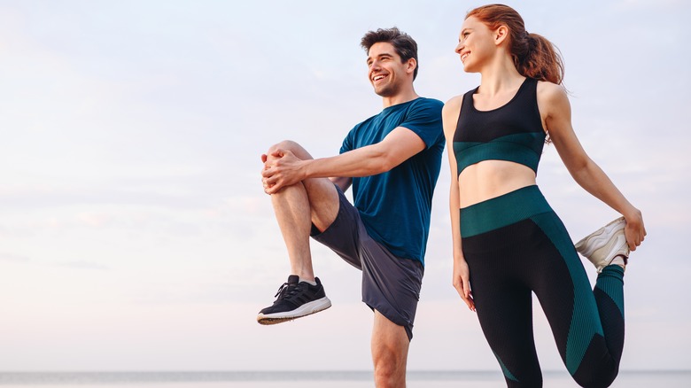 Woman and man stretching