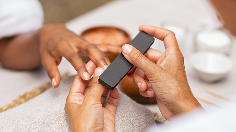 manicurist working on nails