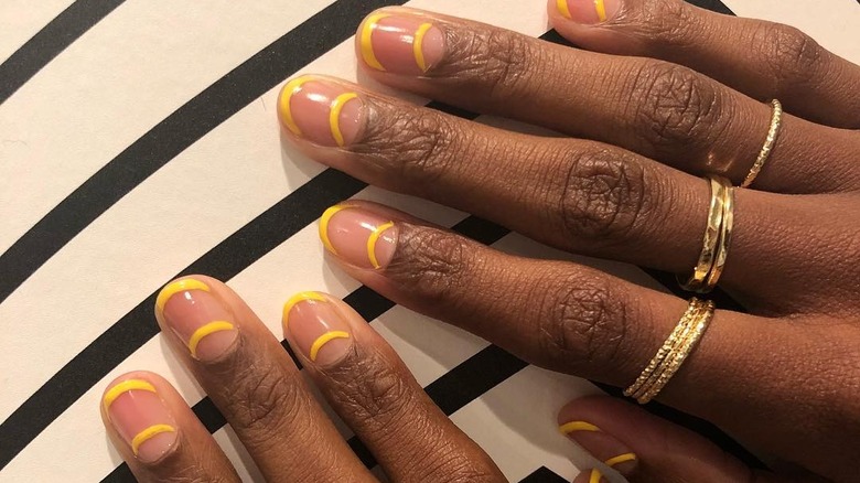 nails with two yellow lines 