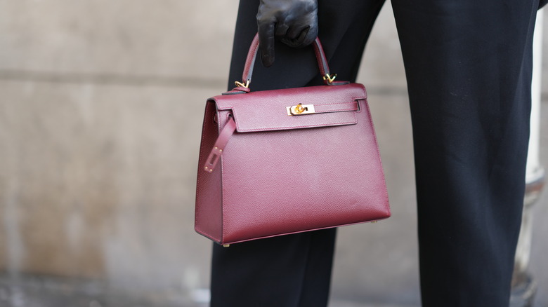 woman wearing cherry black bags