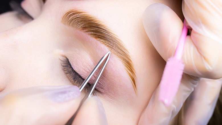 Eyebrow plucking and shaping