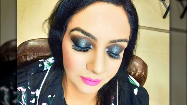 woman with pink lipstick and black eyeshadow