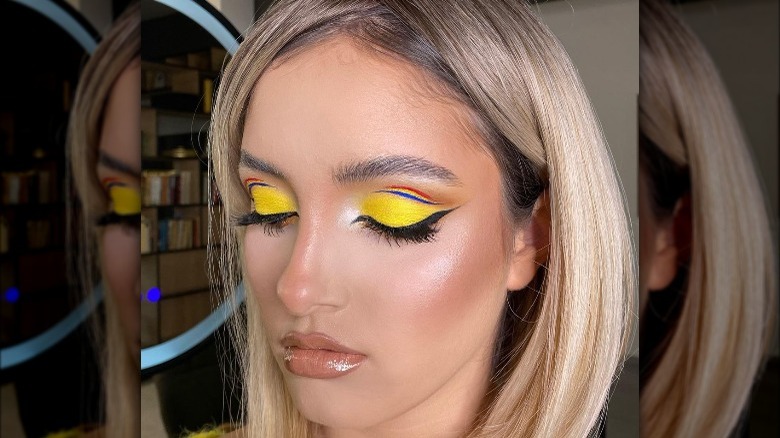 makeup artist wearing yellow eyeshadow