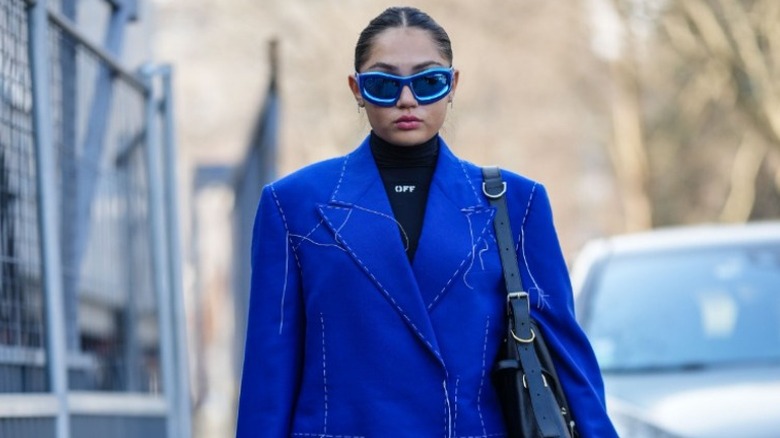 middle part with striking blue outfit