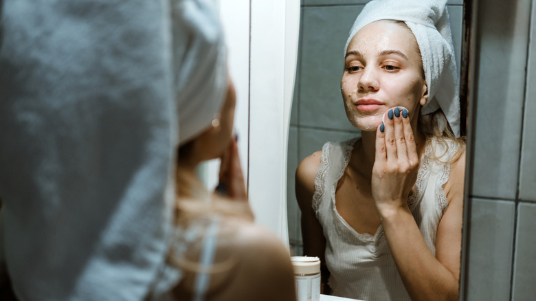 woman washing off clay mask