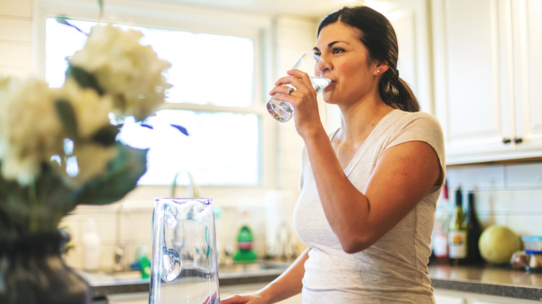 woman drinking glass of water 