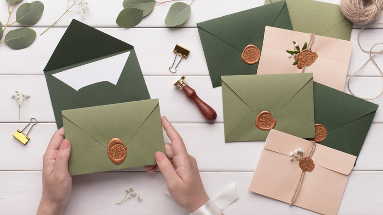 Bride making pink and green invitations