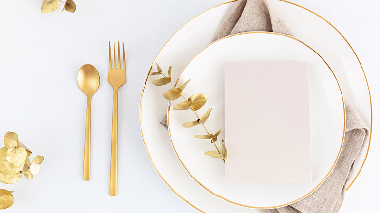 Place setting with gold flatware 