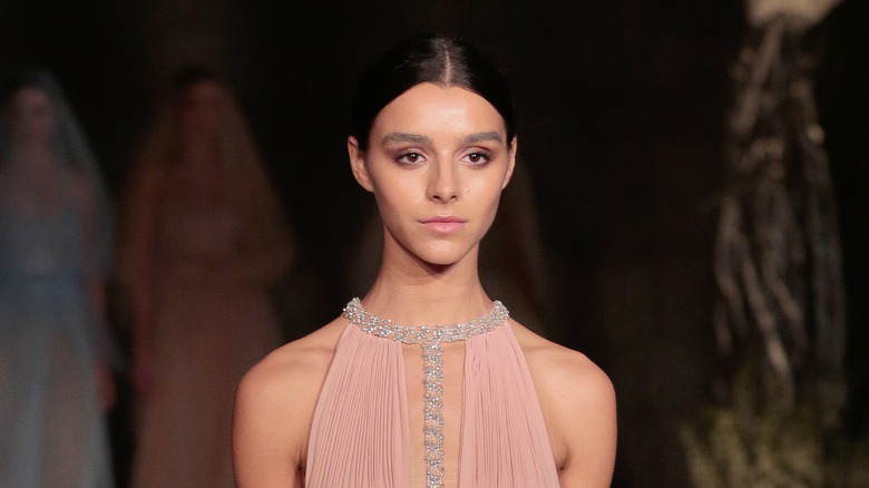 Model in pink dress with bold brows