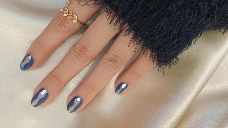 person with blue hourglass nails