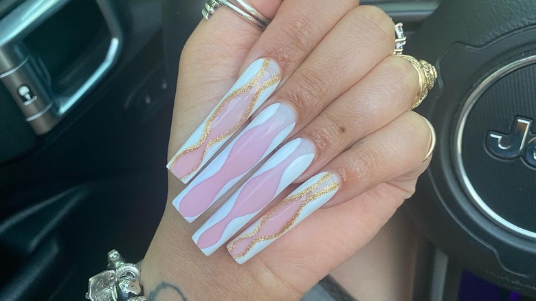 person with long hourglass nails
