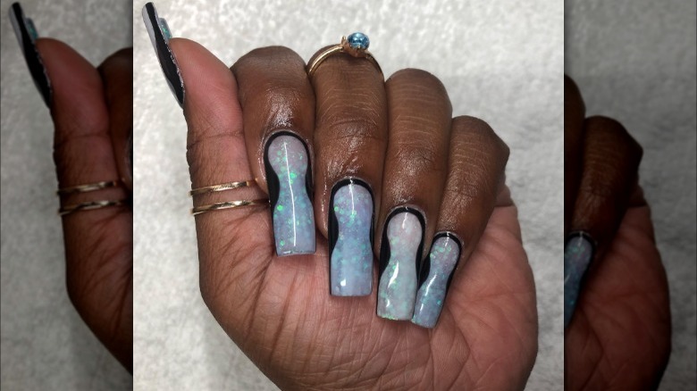 person with shimmery hourglass nails