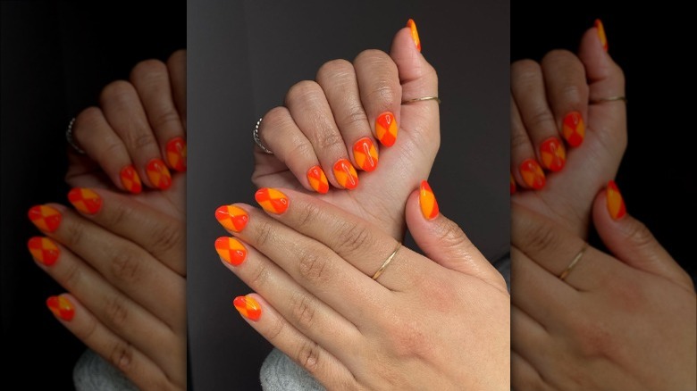 person with orange hourglass nails