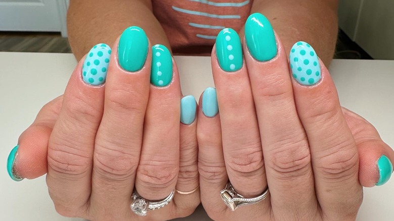 Manicure with teal, blue nails