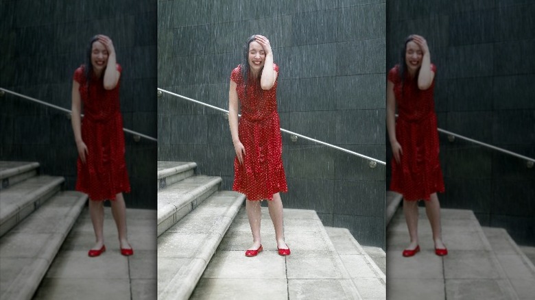woman wearing red dress in rain