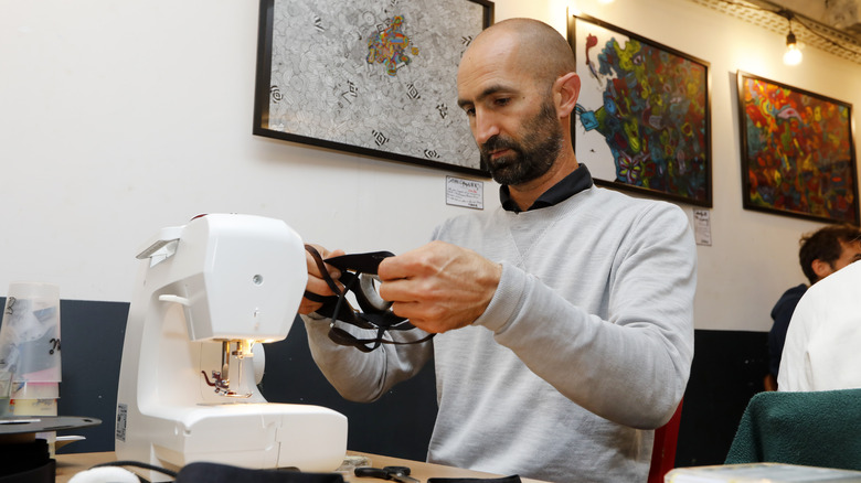 bald man sewing