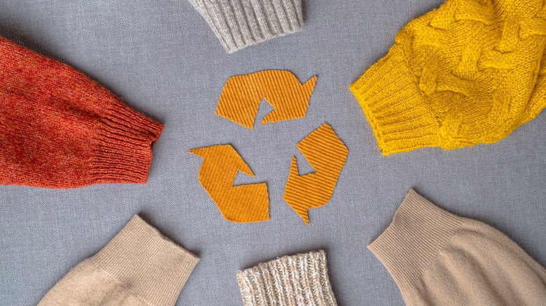 Recycle symbol and sweater sleeves