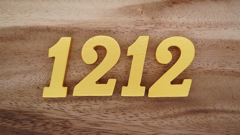 1212 seen on a wooden surface