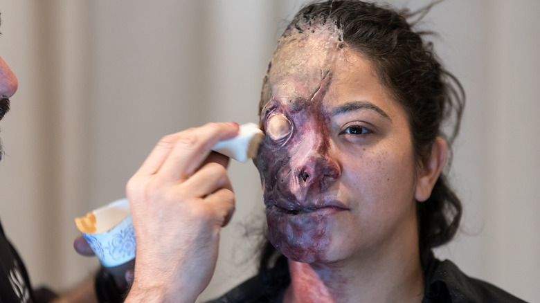 applying prosthetics to a woman's face