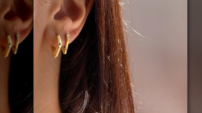 Square huggie earrings on ear