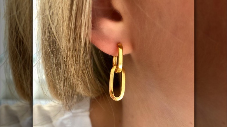 Huggie earrings linked on ear