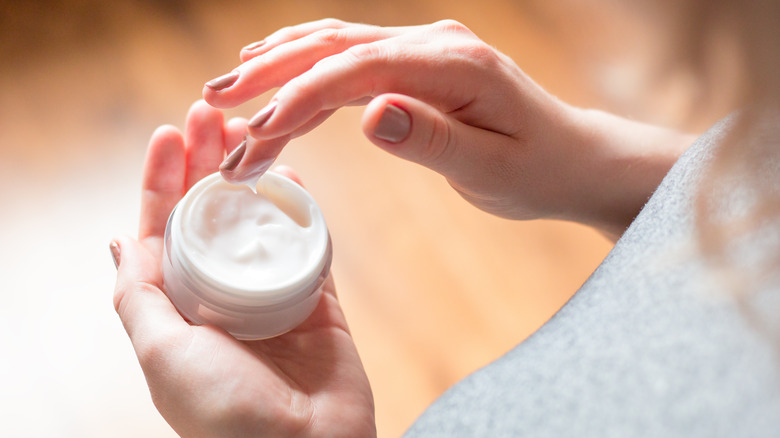 Woman using a face cream