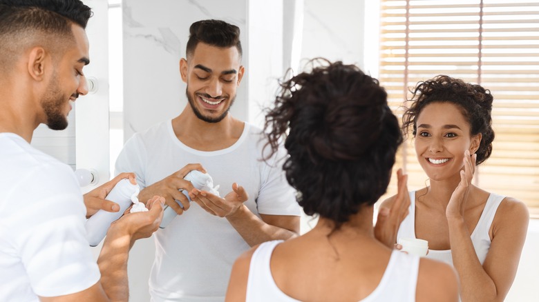 Couple applying skincare products