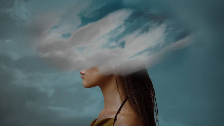 Woman with head in the clouds