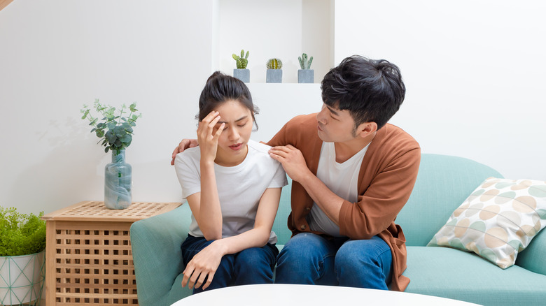 couple sitting on blue couch