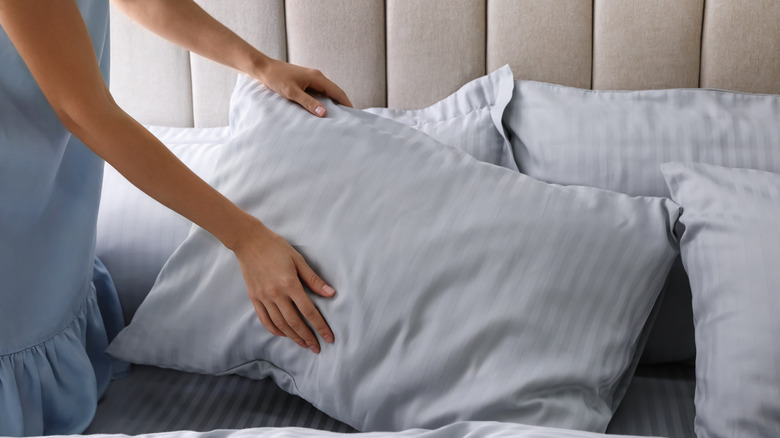 Woman placing pillows