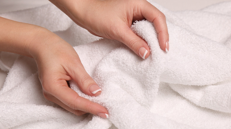 Woman touching white terrycloth