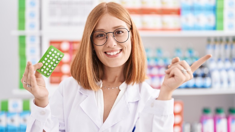 Pharmacist holding birth control pills