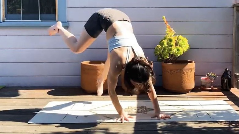 Woman doing animal cartwheel outdoors