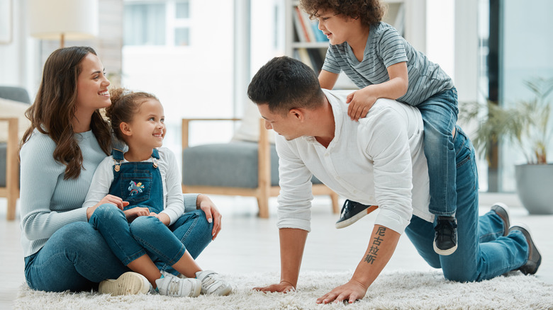 Man crawling with child on his back