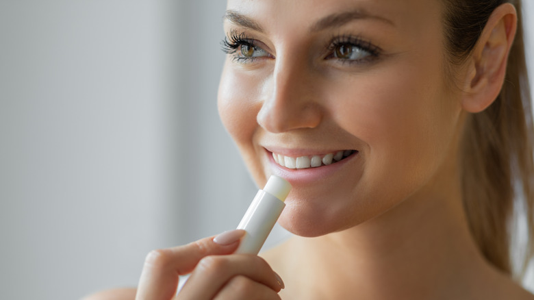 Woman applying lip balm