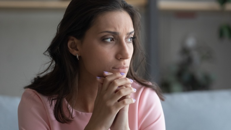 Sad woman sitting on couch