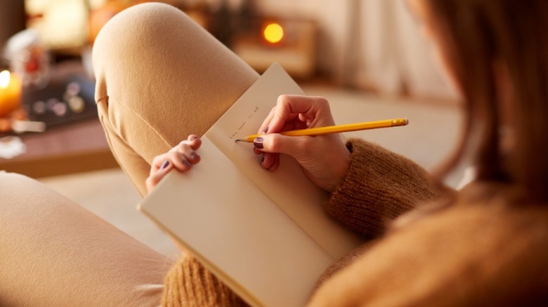 Woman writing in a journal