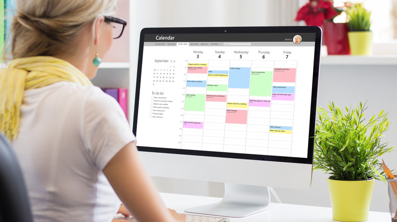 Woman organizes digital calendar 