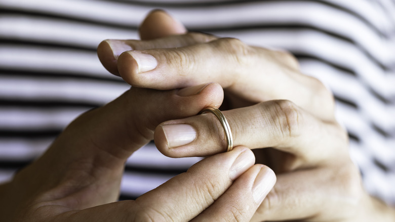 person taking off their ring