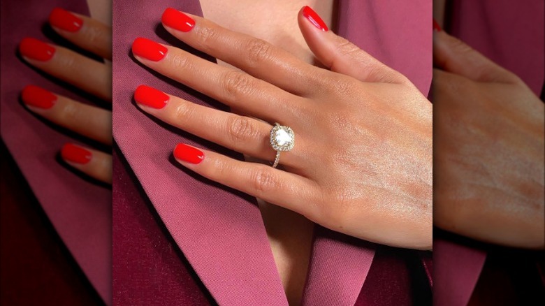 red nail polish on pink jacket