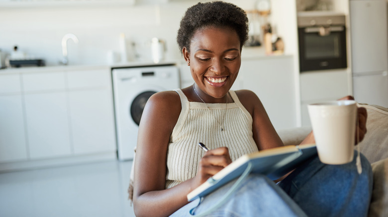 smiling woman journaling