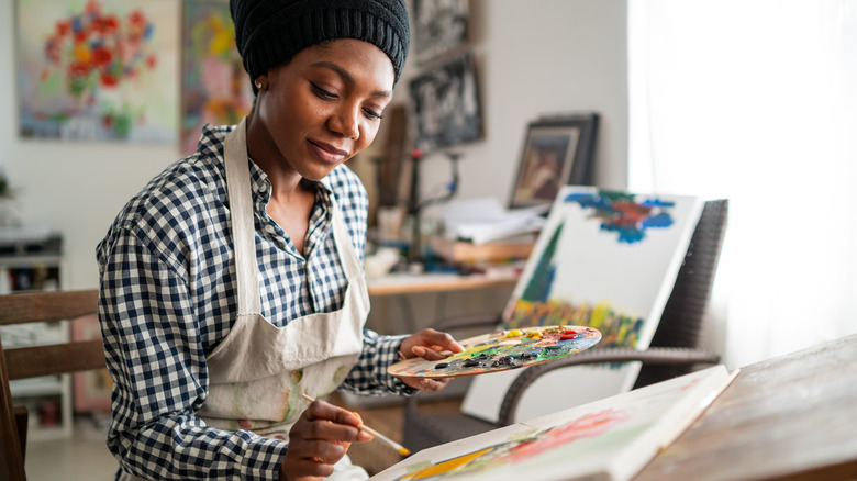 Woman painting in studio